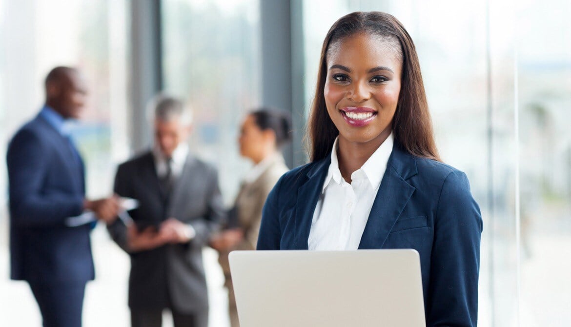 black-woman-standing-with-laywers-in-the-back black-woman-standing-with-laywers-in-the-back